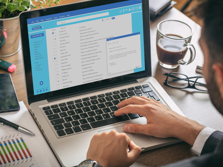person working on emails at their computer